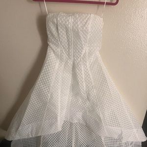 All white “Carrie Vibes” high-low strapless dress